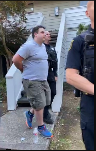 Suspect being detained from his house